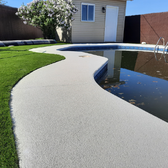 Finition acrylique haut de gamme pour contour de piscine en béton.